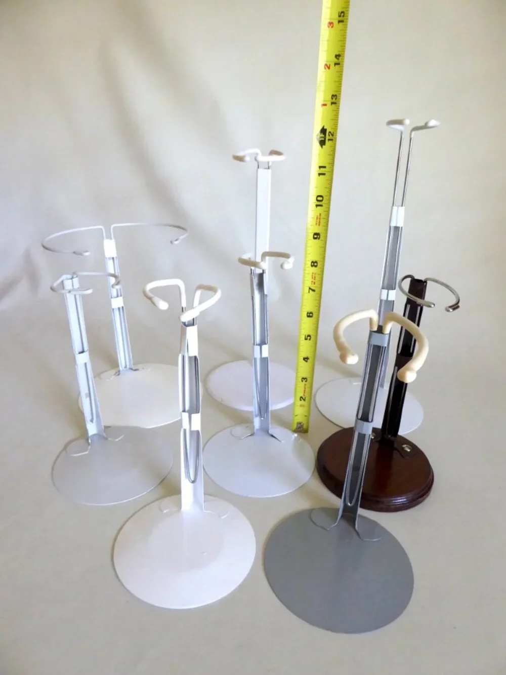 ADJUSTABLE METAL & WOOD BASE ENAMEL DOLL DISPLAY STAND LOT OF 8 (PRE-OWNED)